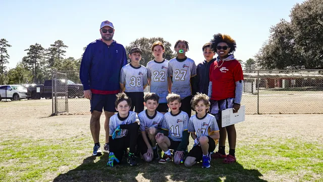 Eddie Gonzalez Loumiet coaching youth athletes on the field in Tallahassee