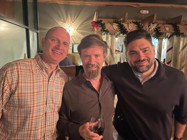 Eddie Gonzalez Loumiet with family and friends at a holiday dinner celebration